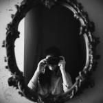 grayscale-photo-of-woman-taking-photo-of-round-mirror-3739059